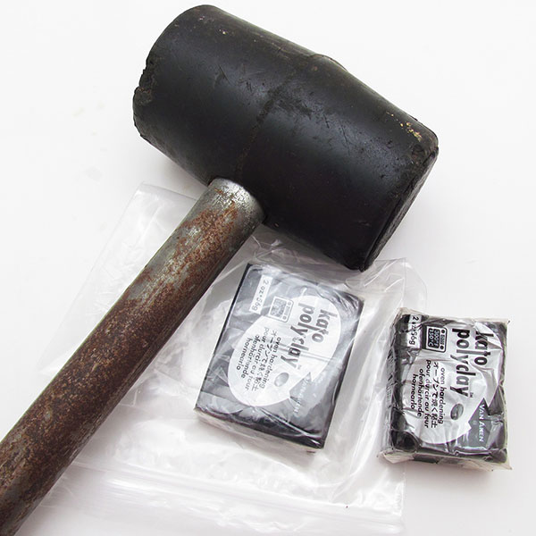 Black Kato polymer clay and a mallet