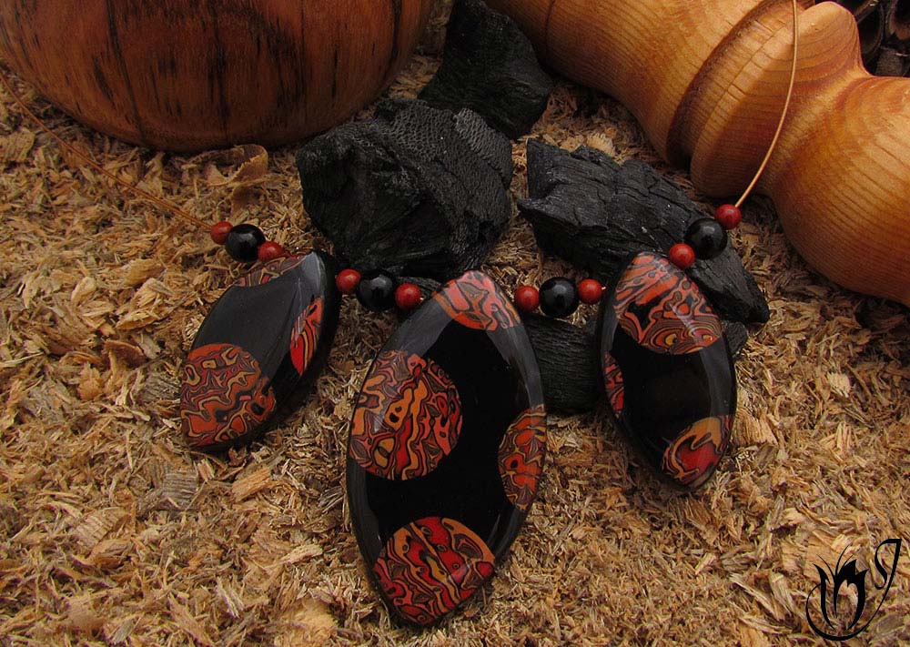 Polymer clay necklace made with Mokume Gane combined with black on accuflex.