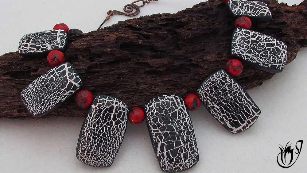 Crackled black and white polymer clay beads combined with faux red coral