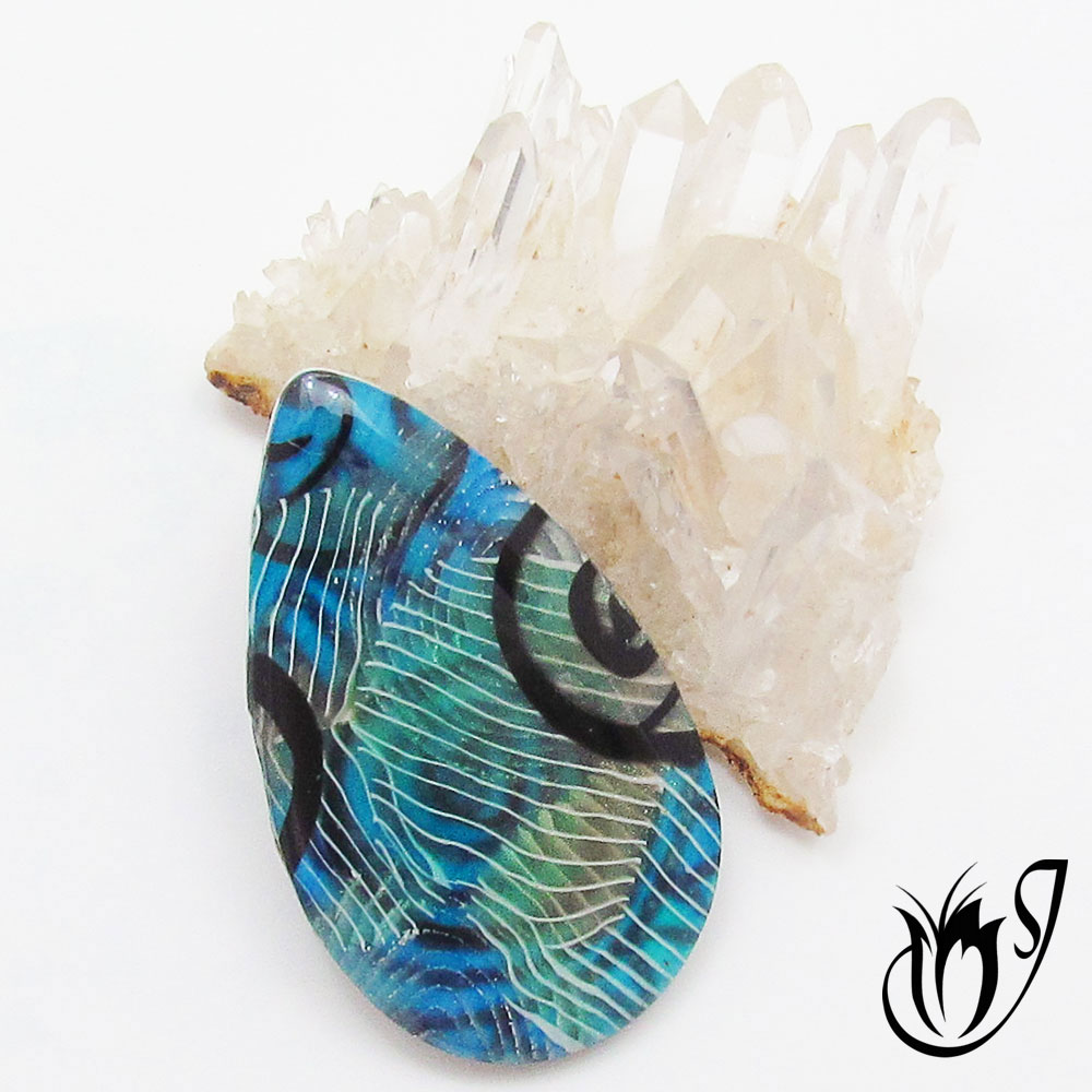 Blue polymer clay pendant with translucent cane slices
